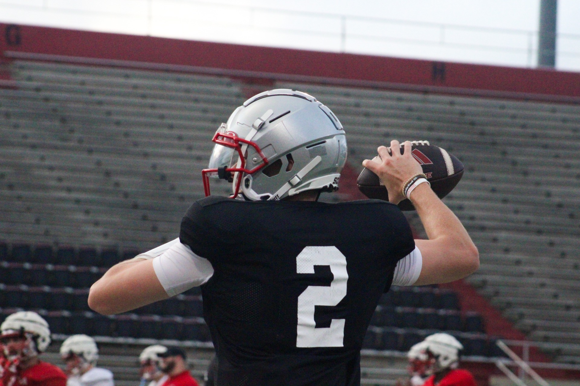 Deuce Hogan throwing a football during quarterback practice